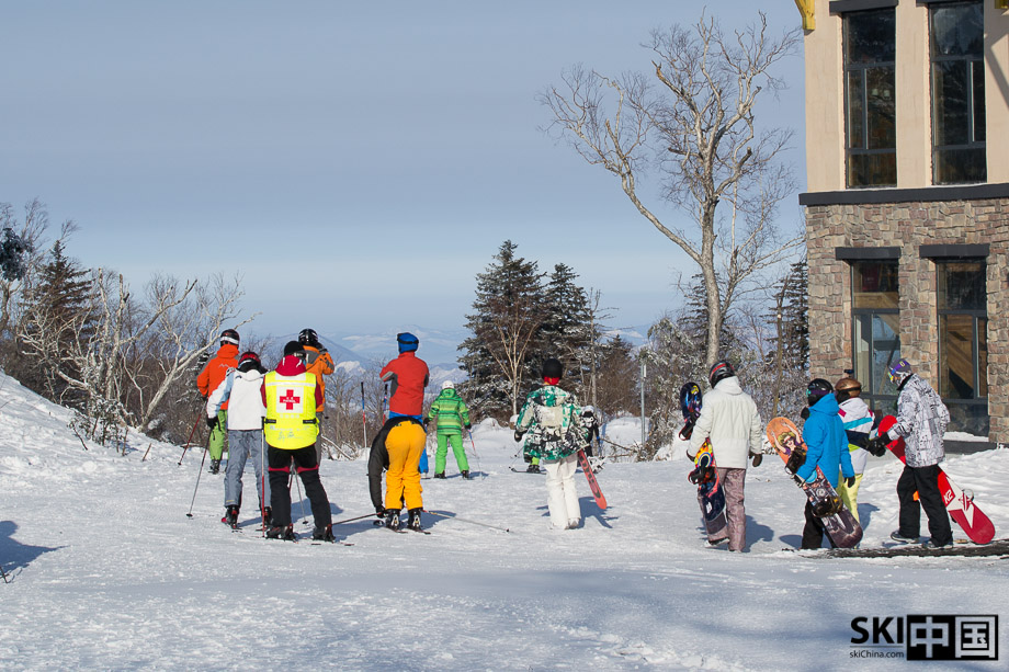 Getting off the lift and strapping in. The building on the top is a lodge